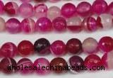 CAG2085 15.5 inches 6mm faceted round fuchsia line agate beads