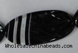 CAG3086 15.5 inches 25*50mm faceted oval black line agate beads