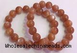 CGB4541 7.5 inches 12mm - 13mm round golden sunstone beaded bracelets